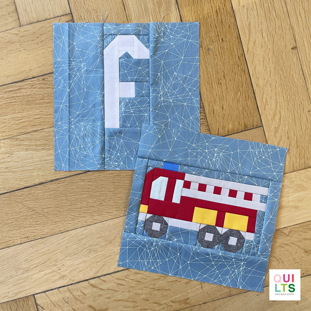 Letter-Vehicle Quilt letter block f und vehicle block fire truck liegt auf Parkett 