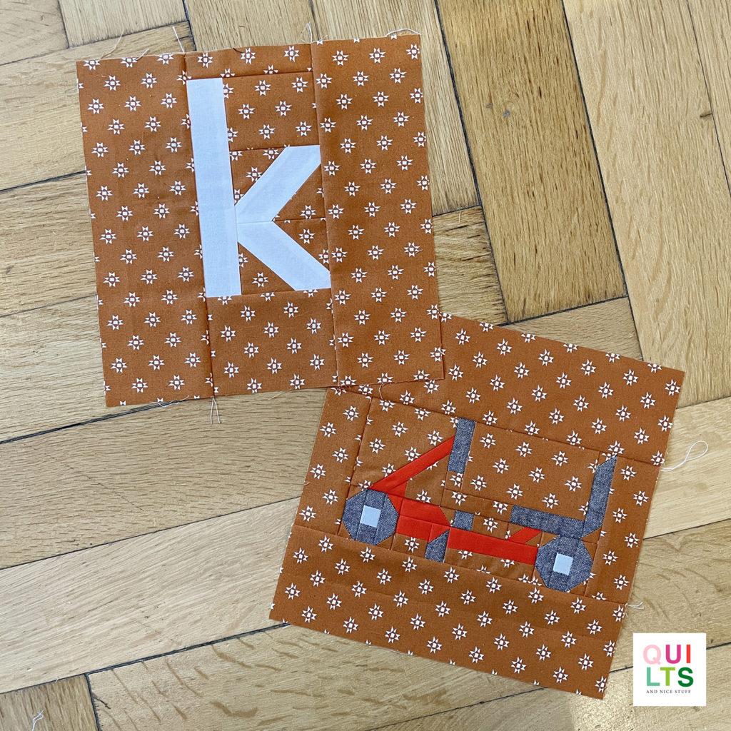 Letter-Vehicle Quilt letter block k und vehicle block kettcar liegt auf Parkett 