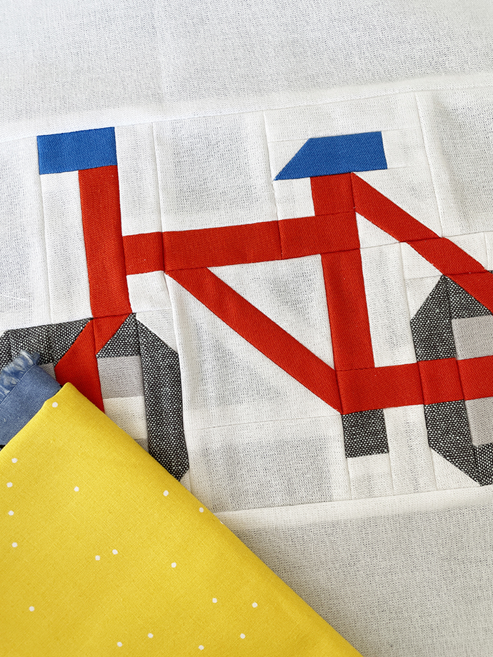 Fahrrad Quilt Block im Anschnitt mit gelbem Stoffstück